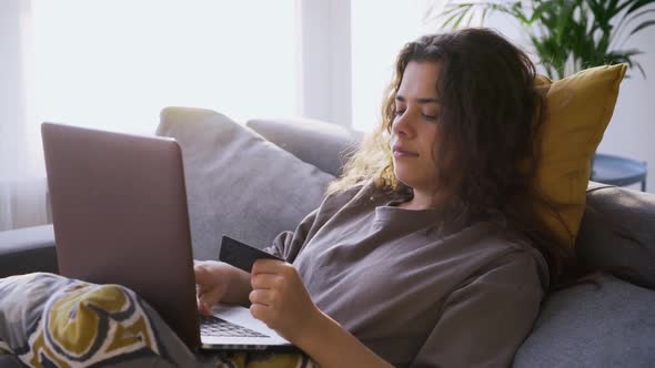 Woman with Credit Card Make Payment on Laptop
