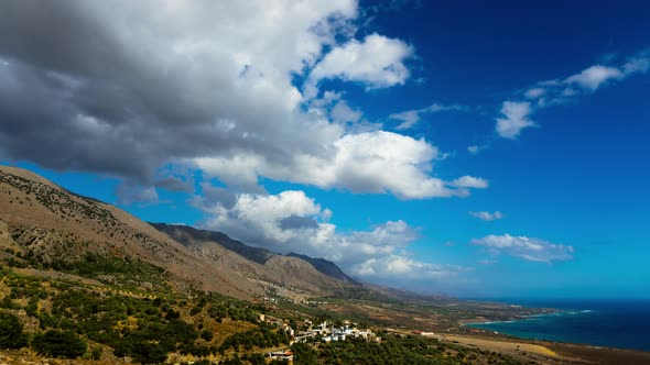 Time Lapse: Mediterranean Sea. White Fluffy Clouds Moving over Hills. alt