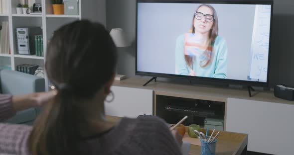 Woman learning English with TV shows