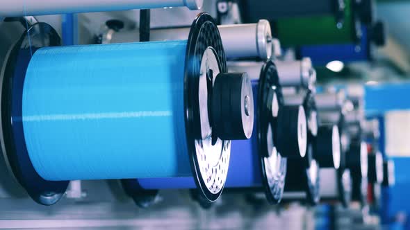 Several Rotating Spools of Wire in a Close Up alt