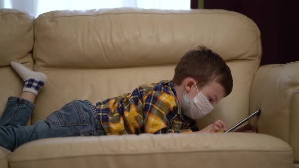 Boy Medical Mask on Face Due To Coronavirus Outbreak alt