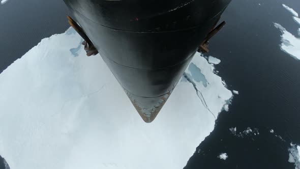 The Bow of the Ship Flies Over the Water with Ice. Chunks of Ice on the Water Crack. The Black Prow