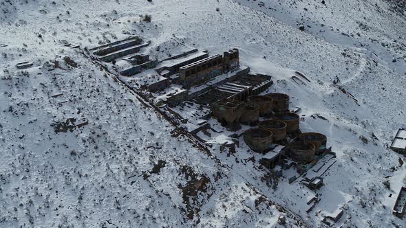 A drone orbits the rusty Old Tintic Mill in Geneloa, Utah, revealing the decaying water tanks, leach alt
