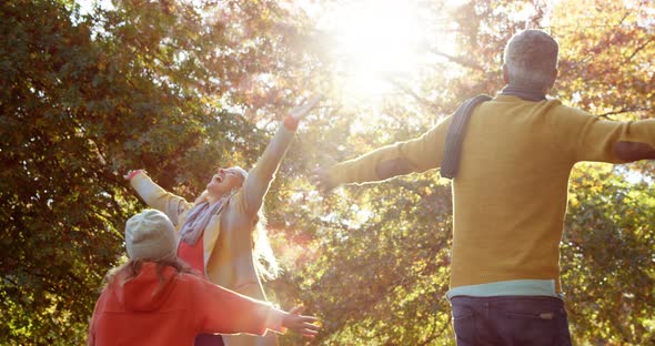 Girl turning with parents all with hands up alt