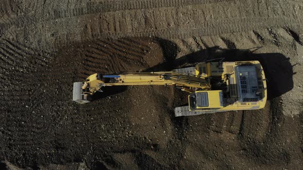 Aerial view of the excavator. The work of the excavator. Digger from the air. alt