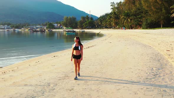 Women best friends on relaxing coast beach wildlife by shallow sea and white sandy background of Tha alt