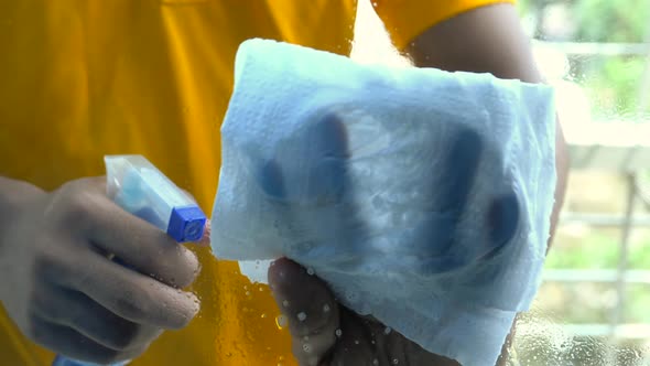 Close Up of Man with Wipe Cloth Cleaning Window Glass  alt