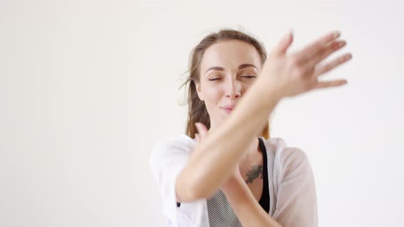 Seductive Woman Dancing and Inviting You with Flirtatious Smile alt