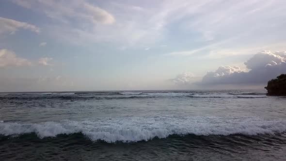 Smooth aerial view lift off aerial drone flight footage of idyllic dream beach with big waves beachf alt