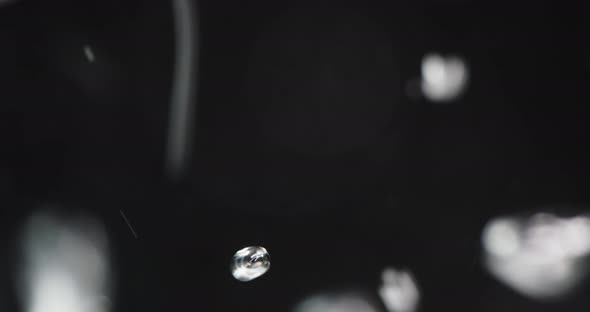 Water Poured Into Liquid Creating Rising Bubbles alt