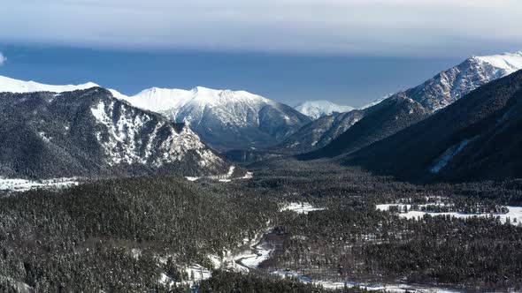 Air Flight Through Mountain Clouds Over Beautiful Snowcapped Peaks of Mountains and Glaciers alt