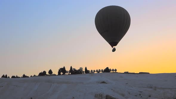 Hot Air Balloons in Travertines of Pamukkale, a Touristic Natural World Heritage Site at Sunrise
