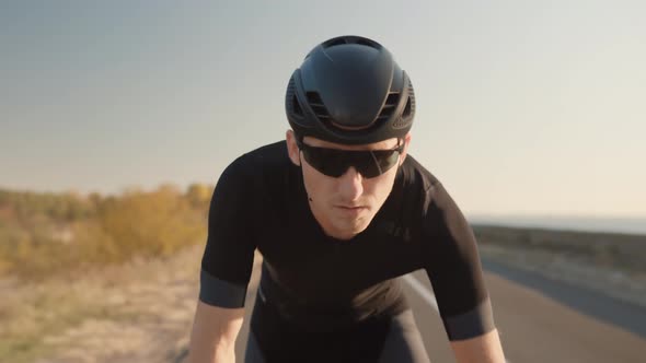 Cyclist Riding On Carbon Bike In Lycra Sportswear. Muscular Fitness Biker Cycling Workout. alt