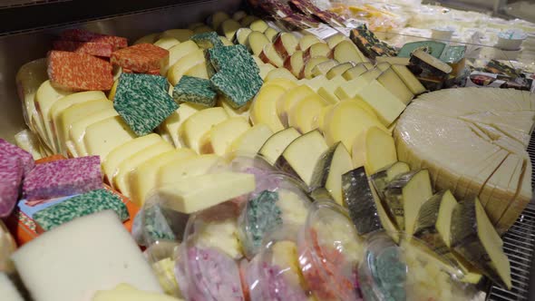 A Large Number of Different Cheeses are on Display in the Store