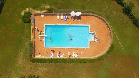 Birds-eye View of People Swimming in Pool alt