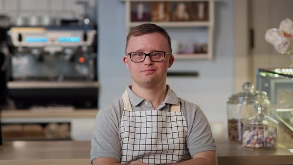 Portrait of caucasian man with down syndrome working in the cafe. Shot with RED helium camera in 8K. alt