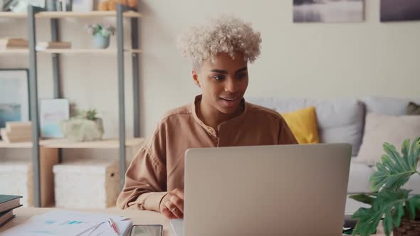 Excited African Business Lady is Enjoying Success at Freelance Work at Home alt