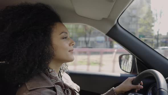 Portrait of a Stylish Young African American Woman Driving a Car alt