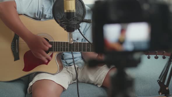Boy Playing Guitar While Live Streaming alt