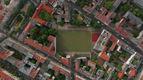 Aerial Birds Eye Overhead Top Down View of Urban Neighbourhood with Football Playground alt