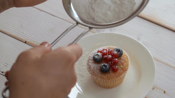 Chef Sprinkled with Powdered Sugar Cupcake Decorated with Berries