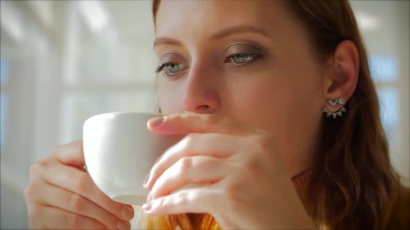 Beautiful Sunny Day Young Woman Drinks Morning Coffee in a Cafe, Making Online a Purchase Easy alt