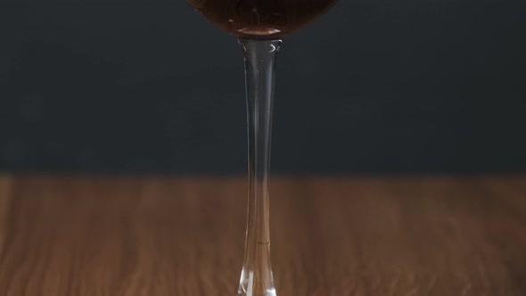Mulled Wine in a Glass with Straws in Restaurant on Black Background alt