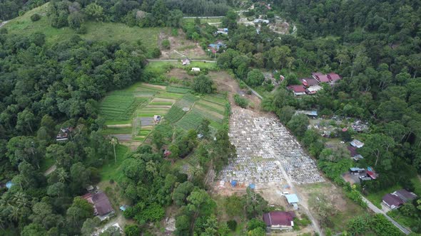 Aerial view cemetery and vegetable at rural village alt
