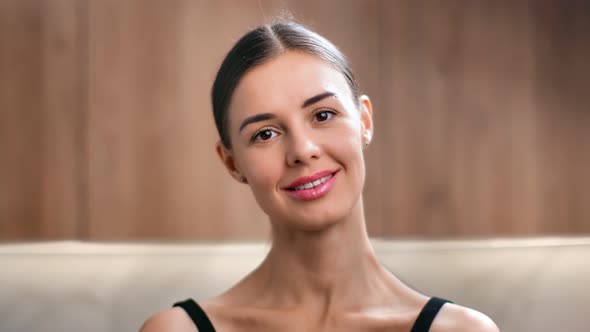 Closeup Portrait of Beautiful Female Smiling Posing at Wooden Kitchen alt