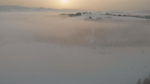 Flying Over Clouds in the Winter Morning Sunrise in Carpathian Mountains alt