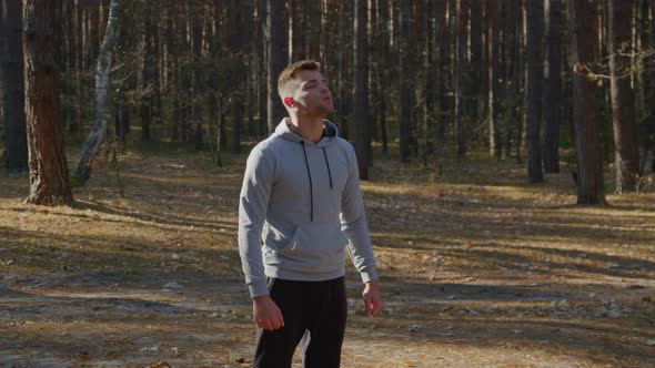 Man Is Warming Up In Forest Before Morning Workout