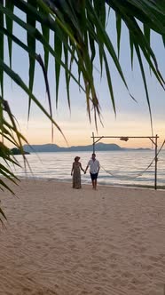 Men and Women Walking on the Beach in Pattaya During Sunset in Thailand Ban Amphur Beach alt