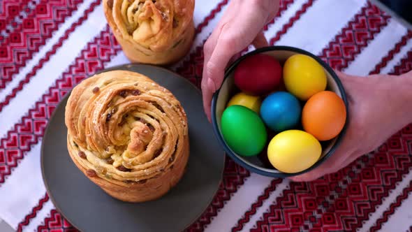 Young Woman Puts Fresh Baked Easter Cake Cruffin on Kitchen Table alt