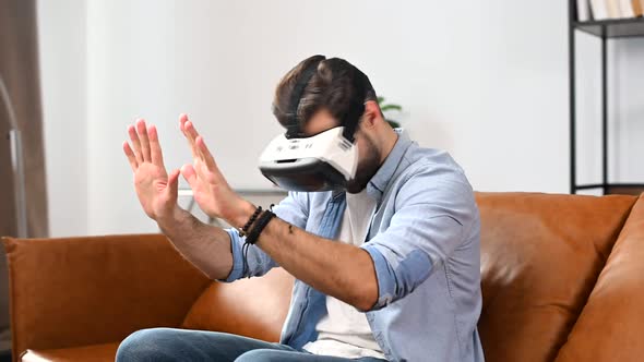 Excited Young Man Wearing VR Goggles alt