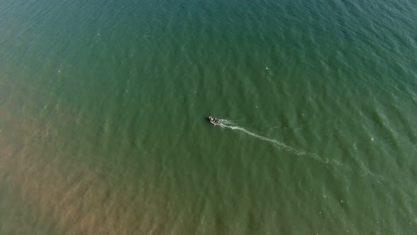 Aerial Shot of a Wooden Boat Fishing on the Black Sea Shallow in Summer