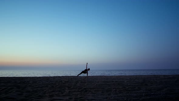 Silhouette Yoga Woman Training Warrior Asana in Front Beautiful Sunset Sky alt
