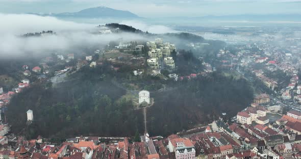 The Aerial Urban Landscape of the City in an Autumn Foggy Sunrise Morning