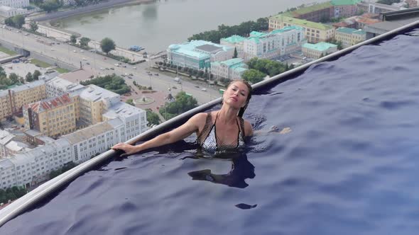 Attractive Woman in Swimming Pool on Roof