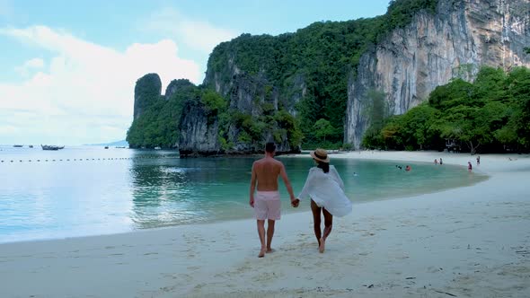 Couple Men and Woman on the Beach of Koh Hong Island Krabi Thailand Asian Woman and European Men on alt