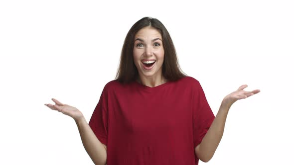 Attractive Brunette Girl in Red Tshirt Looking Surprised with News Smiling and Shaking Head alt