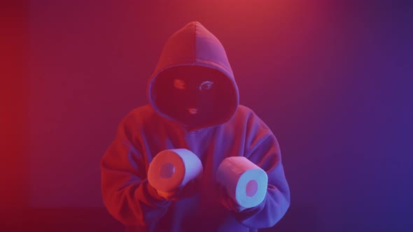 a thief in a mask with toilet paper in his hands
