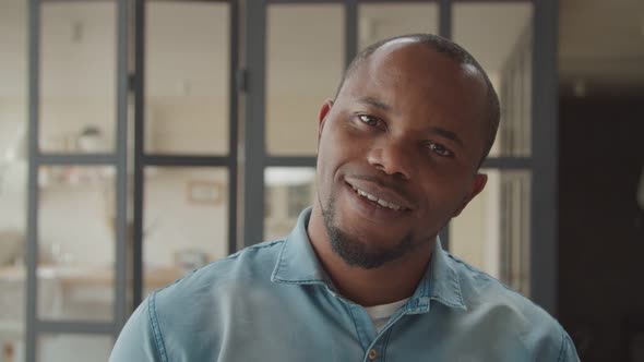 Cheerful African Guy Laughing Sincerely Indoors alt