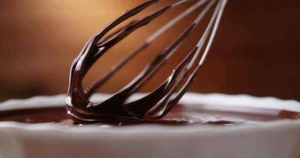Closeup Chocolatier Mixing Melted Liquid Chocolate with Steel Whisk alt