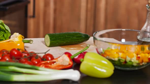 Preparing vegetables salad - cutting different ingredients, stop motion with moving camera
