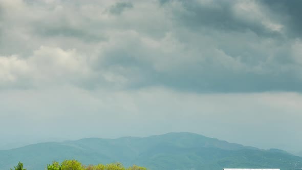 Rural Time Lapse with Rustic Cabins Against Mountains and Cows alt