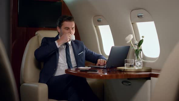 Finance Manager Take Sip of Coffee on Business Trip alt