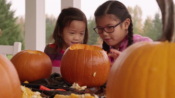 Kids carving pumpkins for Halloween