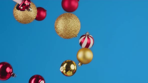 Flying Christmas Balls Against Blue Background