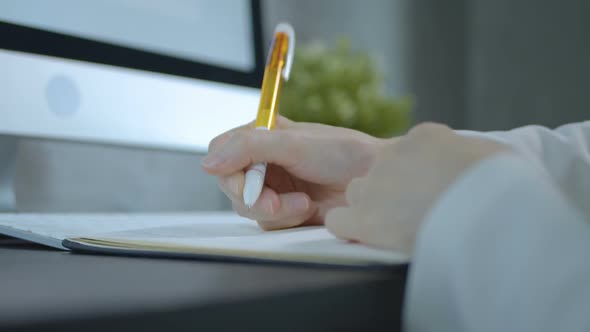 Female Hand Writing On Notebook alt