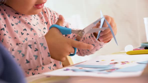 Toddler cutting with scissors and doing crafts